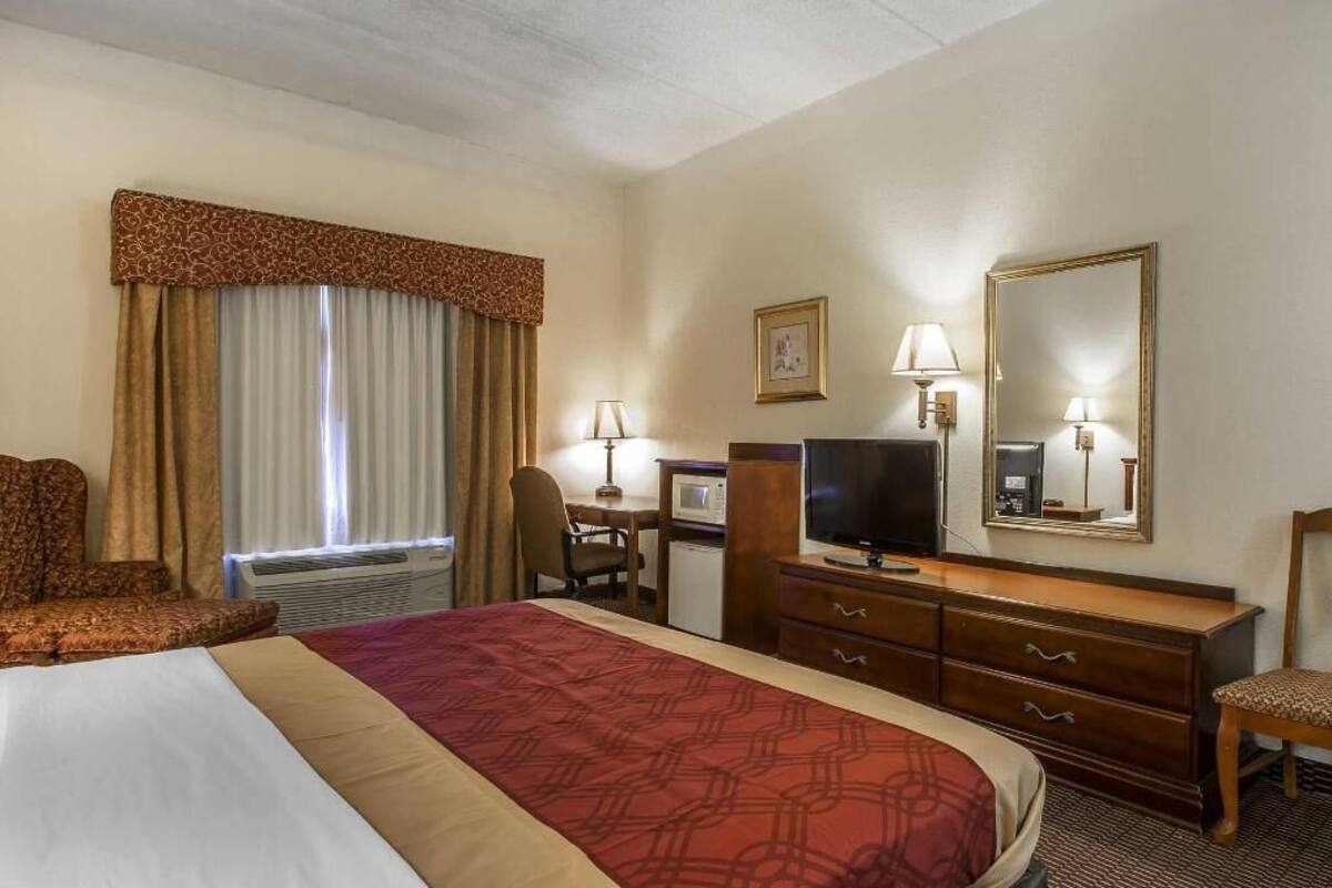 Desk, iron/ironing board, bed sheets