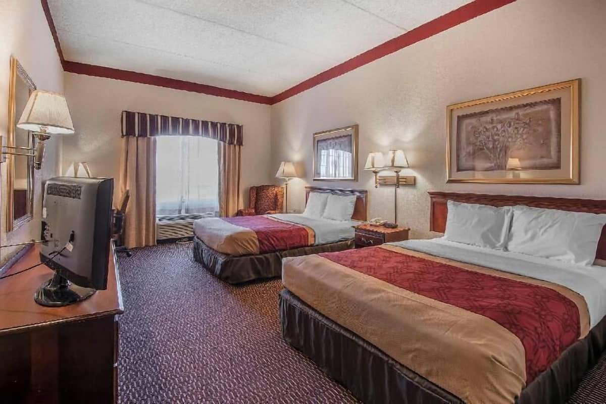 Desk, iron/ironing board, bed sheets