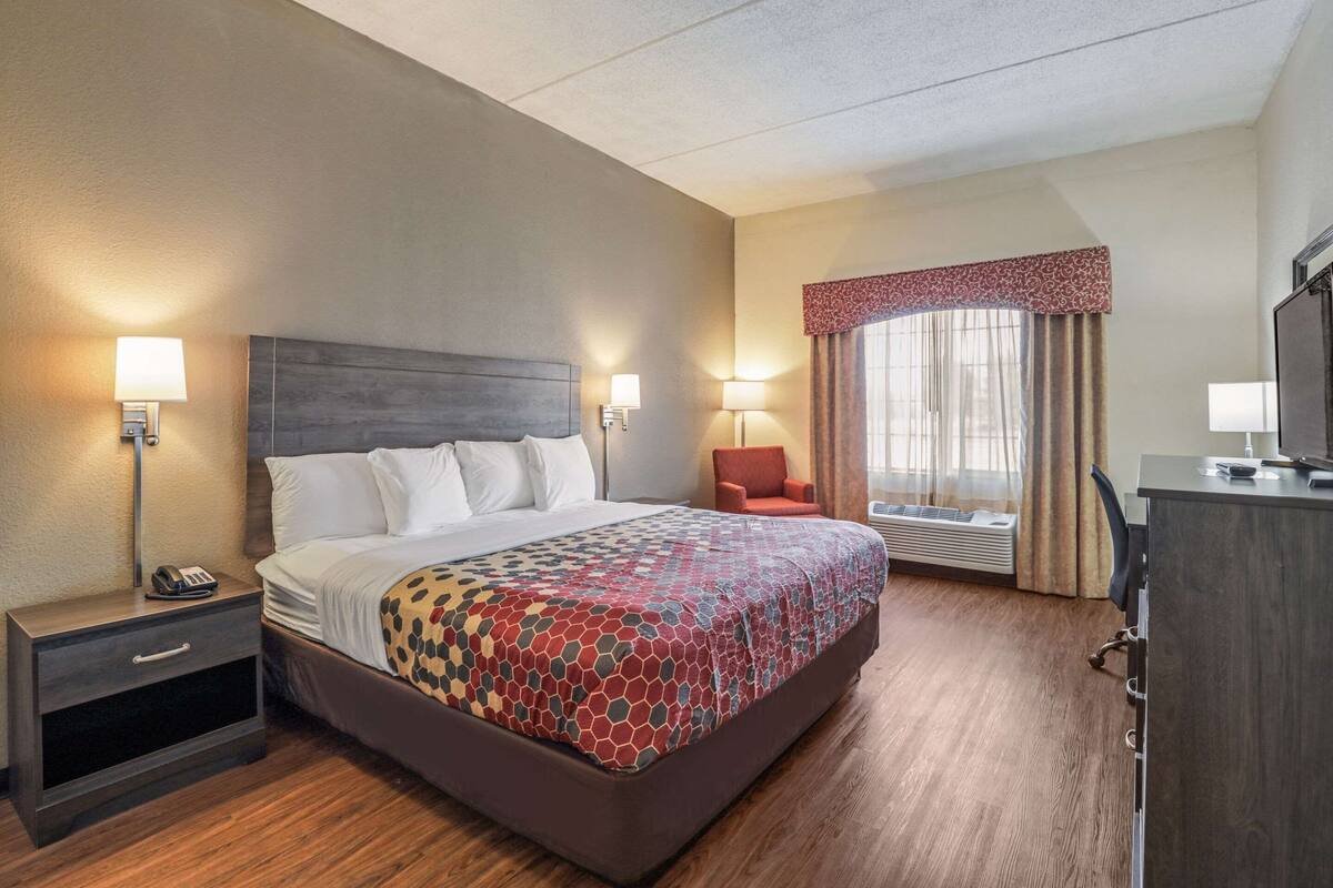 Desk, iron/ironing board, bed sheets
