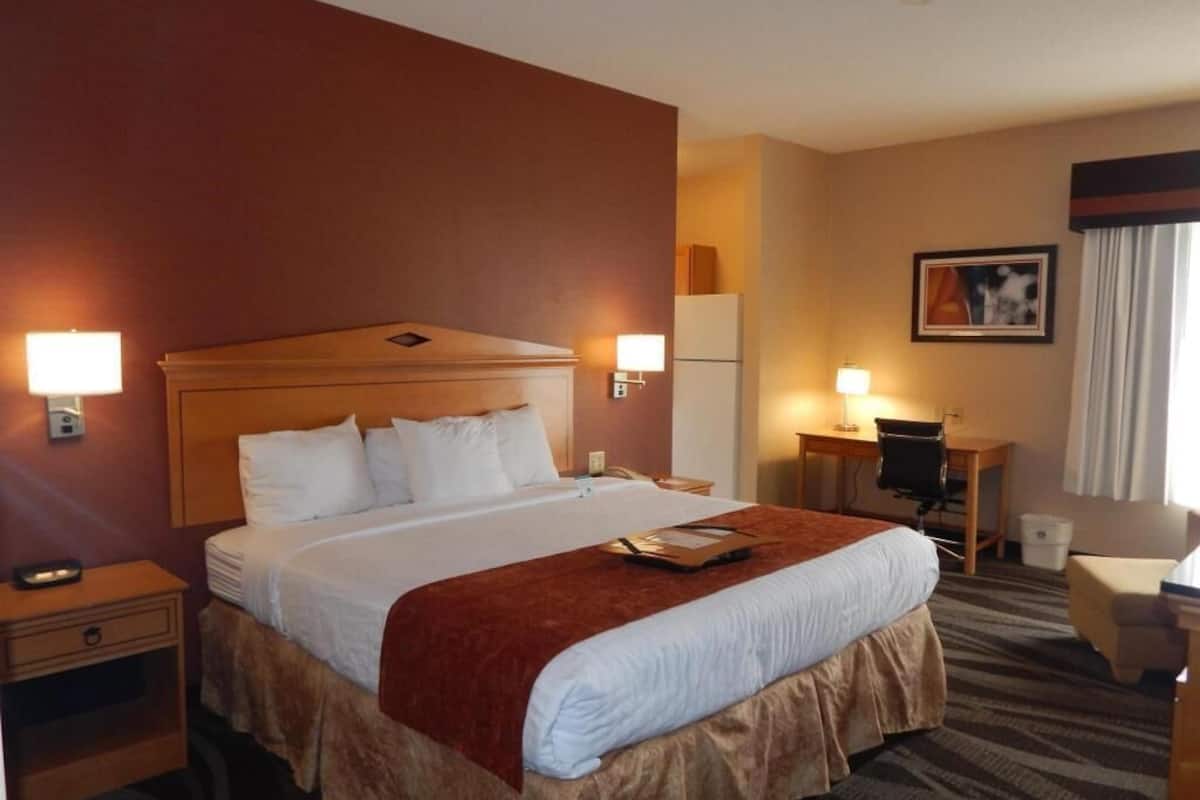 Premium bedding, desk, laptop workspace, blackout drapes