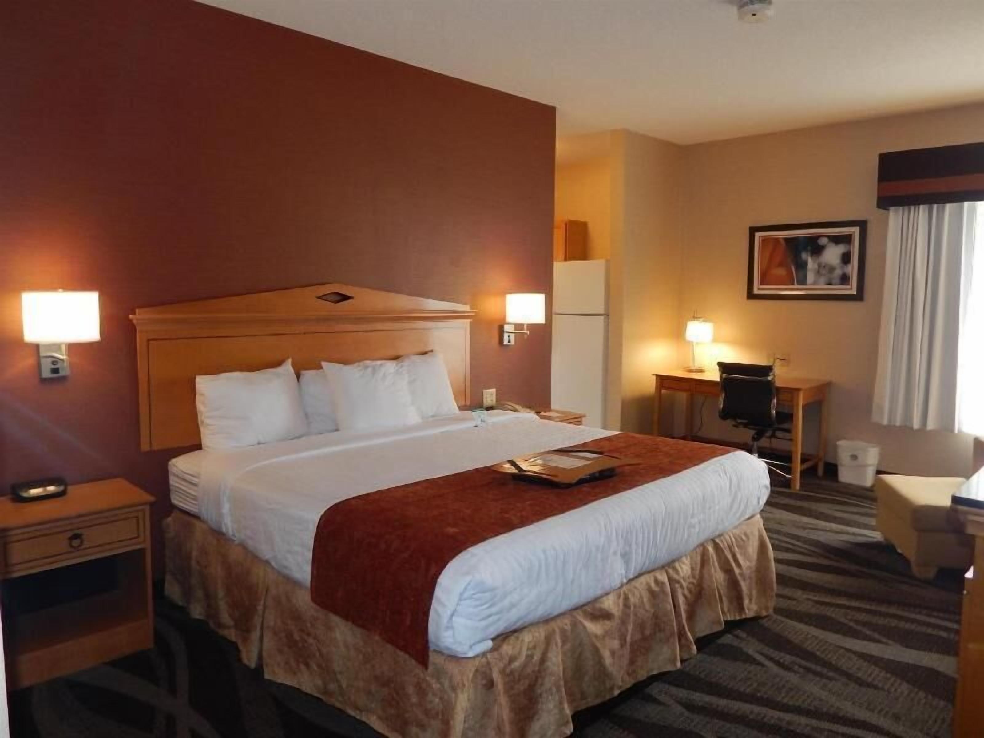 Premium bedding, desk, laptop workspace, blackout drapes