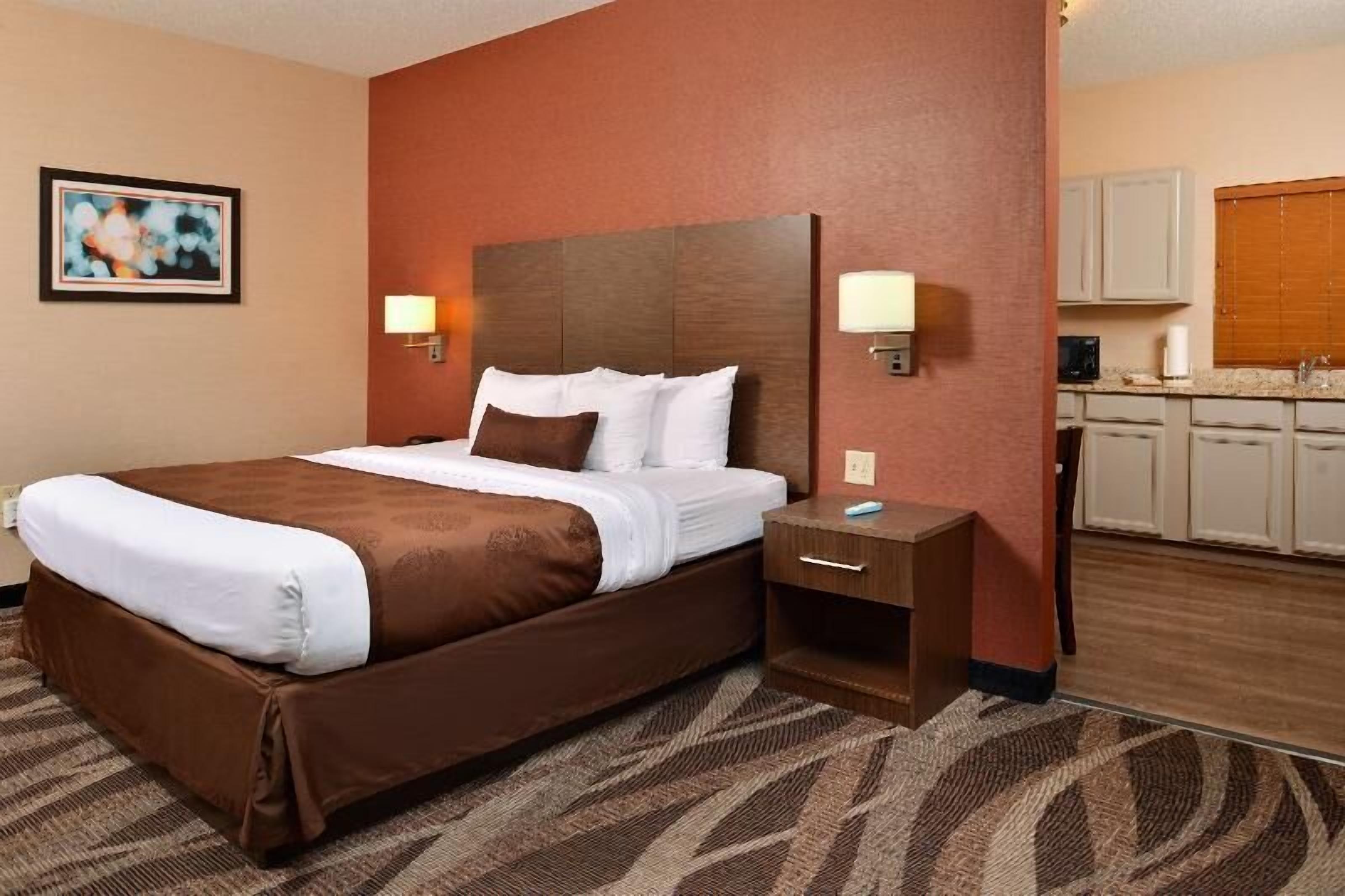 Premium bedding, desk, laptop workspace, blackout drapes
