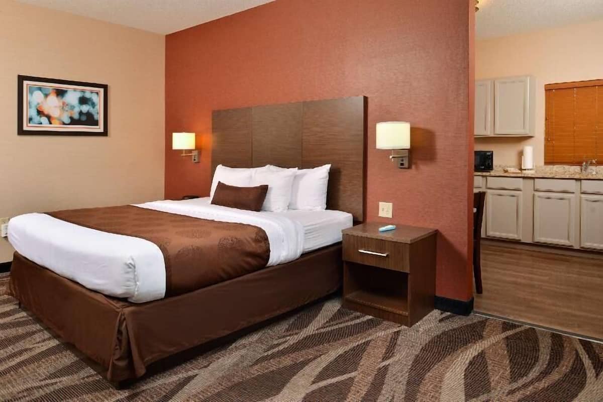 Premium bedding, desk, laptop workspace, blackout drapes