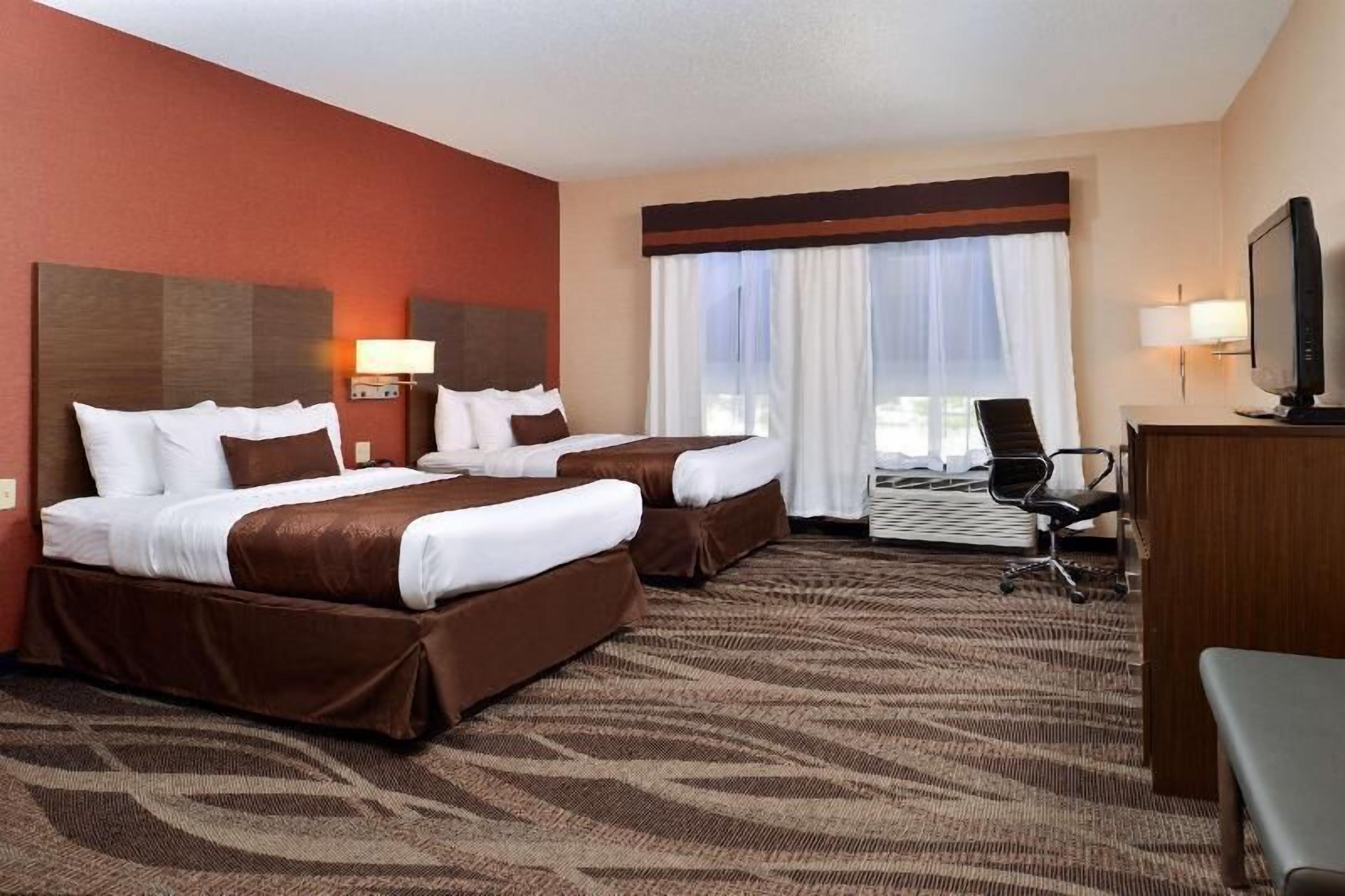 Premium bedding, desk, laptop workspace, blackout drapes