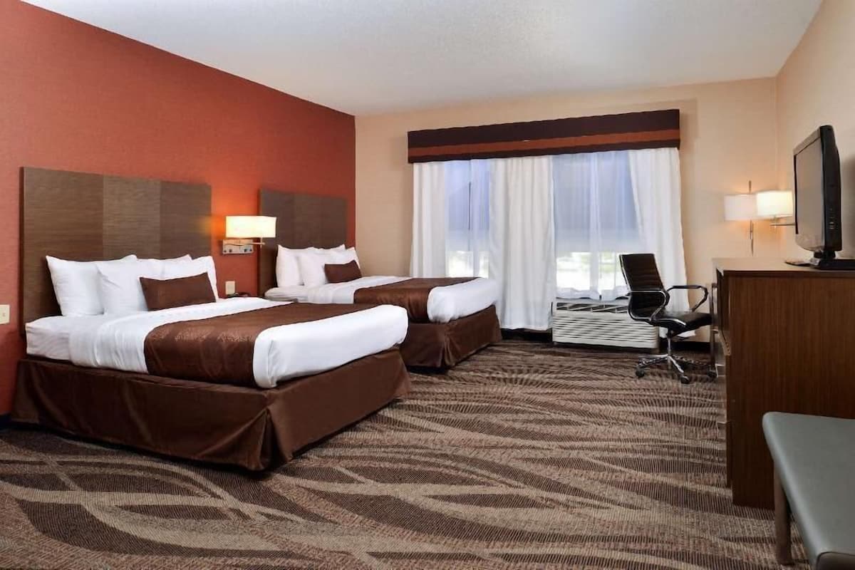 Premium bedding, desk, laptop workspace, blackout drapes