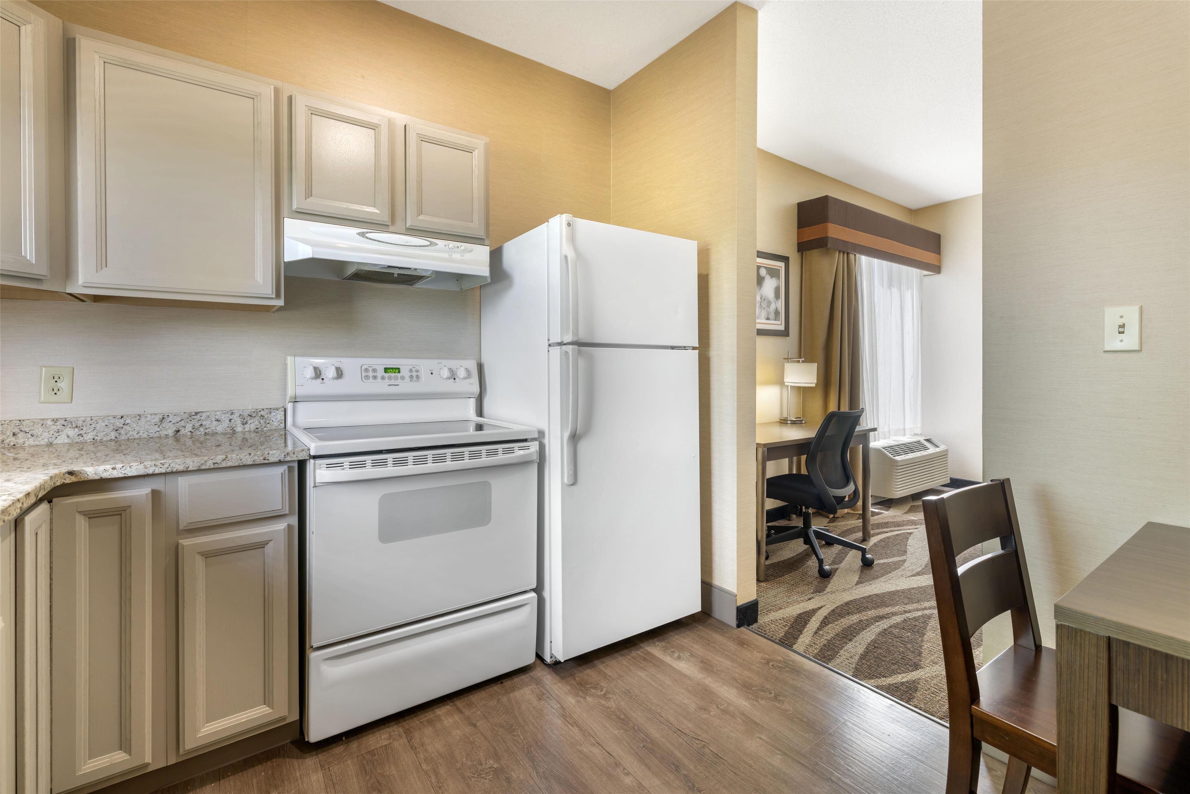 Premium bedding, desk, laptop workspace, blackout drapes