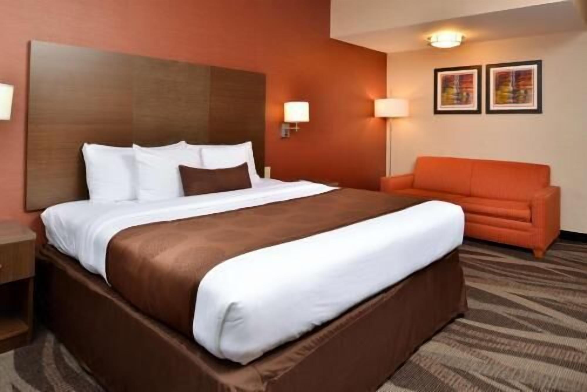 Premium bedding, desk, laptop workspace, blackout drapes