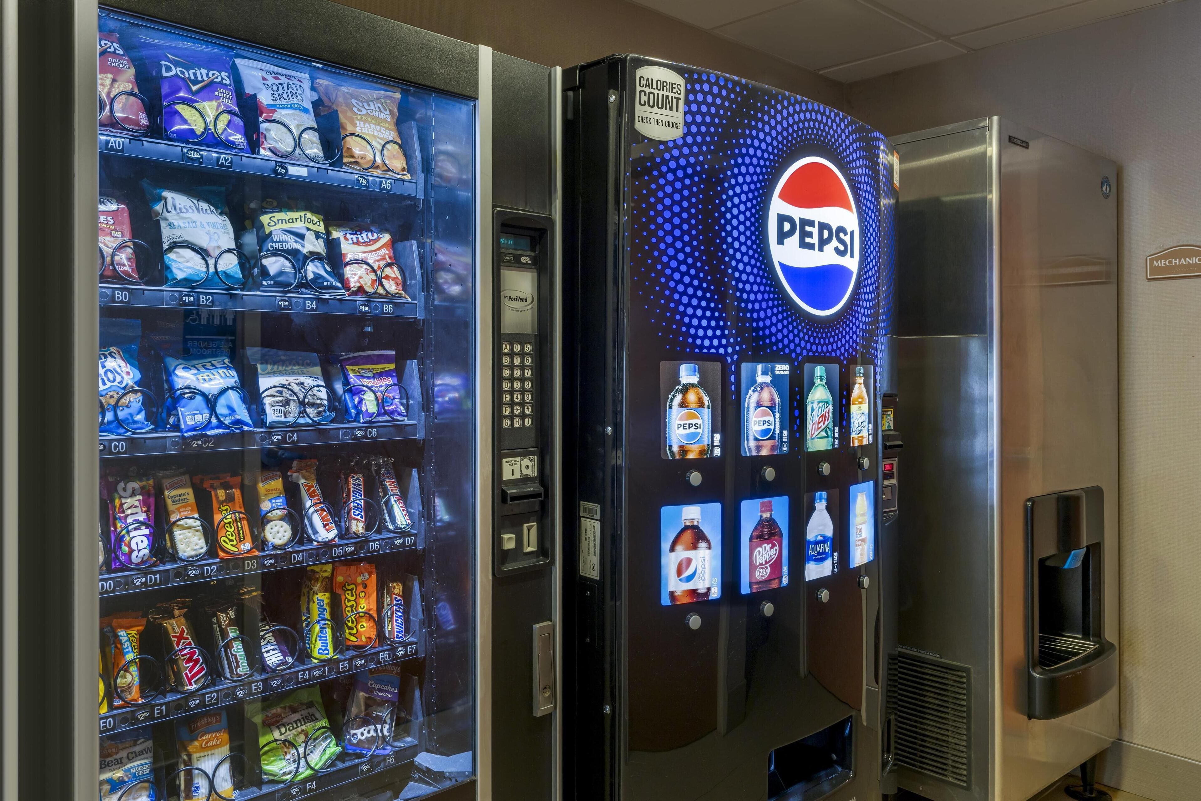 Máquina expendedora con aperitivos y un refrigerador de Pepsi.