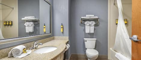 A bathroom with a sink, toilet, and shower.