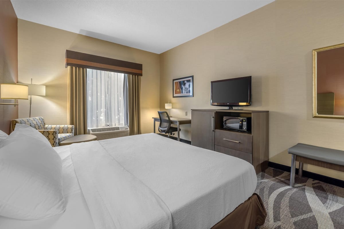 Premium bedding, desk, laptop workspace, blackout drapes