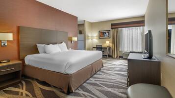 Premium bedding, desk, laptop workspace, blackout drapes