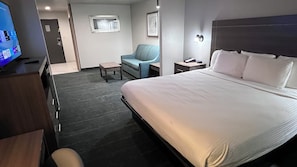 A hotel room with a bed, a desk, a chair, a television, and a small table. - Best Western Plus Memorial Inn & Suites (Oklahoma City)