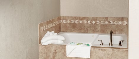 A bathroom with a bathtub, a shower, and a toilet.