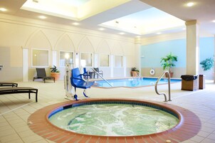 Una piscina techada, sillones reclinables de piscina