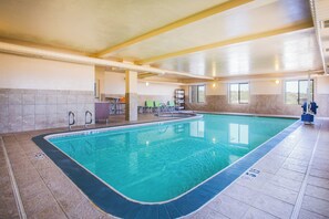 An indoor swimming pool with clear water, surrounded by tiled walls and a ceiling with exposed ductwork. - Holiday Inn Express & Suites Cedar City by IHG (Cedar City)