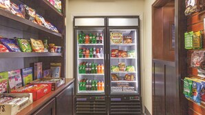 Zona de máquinas expendedoras con aperitivos, bebidas y juegos de lógica.