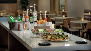 A buffet setup with various food items and condiments. - Residence Inn by Marriott Washington, DC National Mall (Washington)