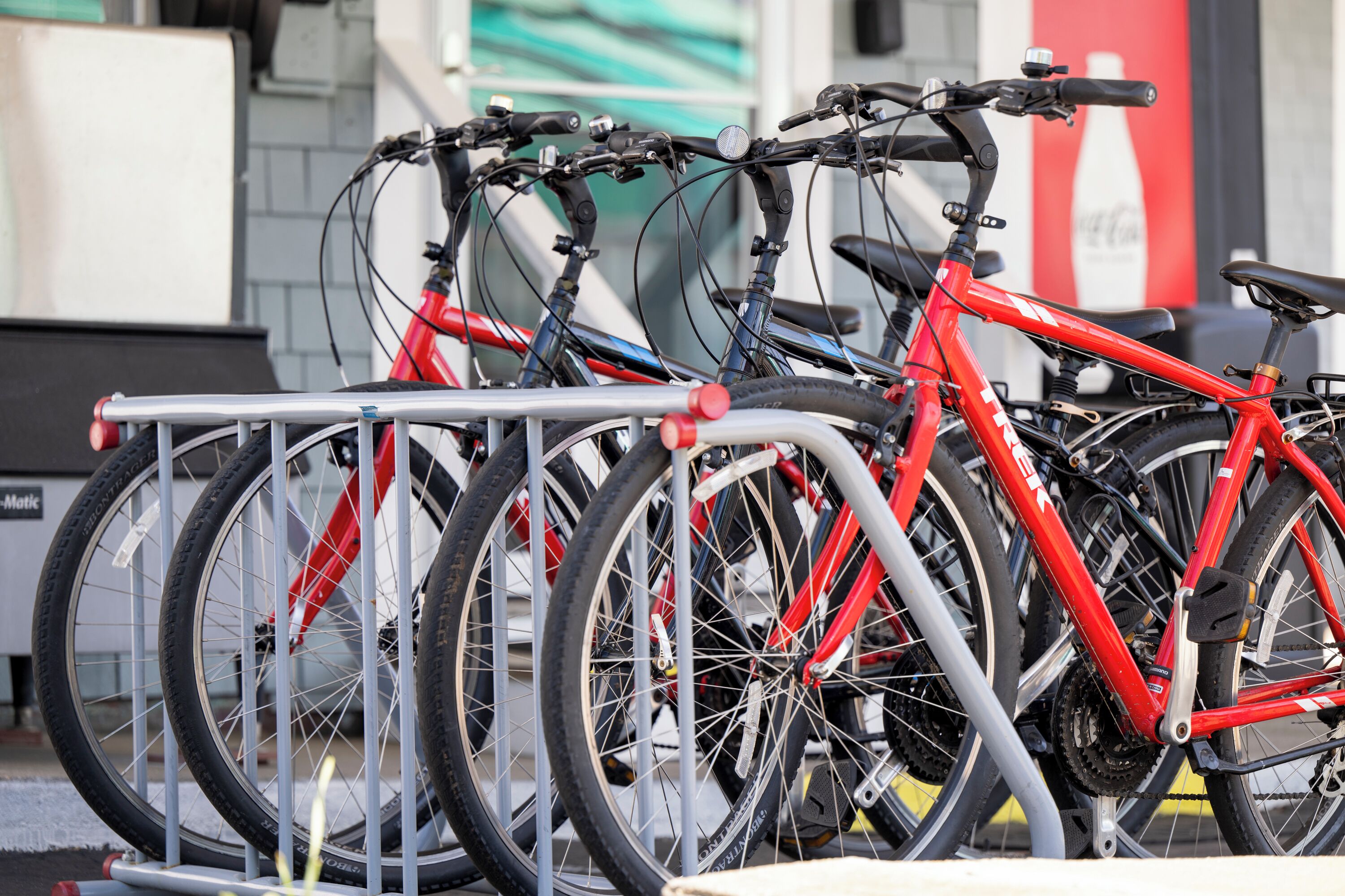 A bicycle rack with multiple bicycles parked.