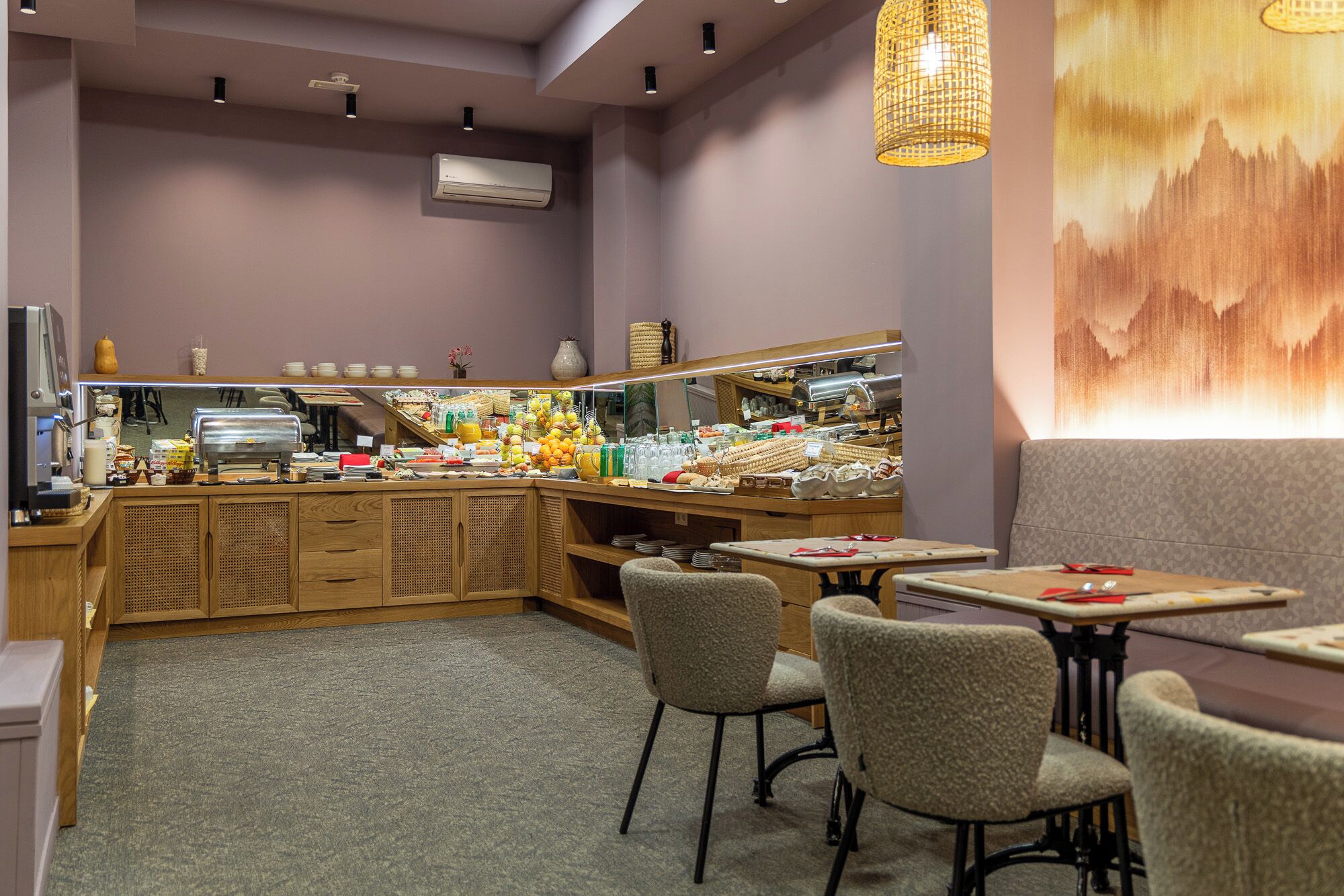 A restaurant with a buffet, wooden cabinets, and a large painting on the wall.