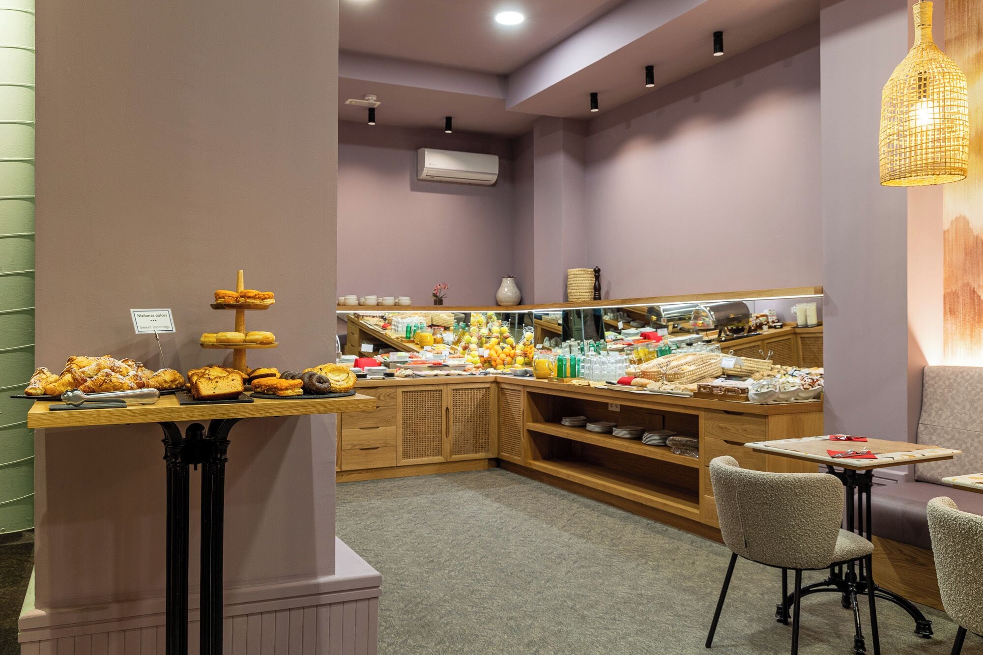 A breakfast buffet with various pastries and fruits.