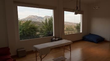 Enjoy breathtaking views of the surrounding mountains and lush greenery from this serene room.