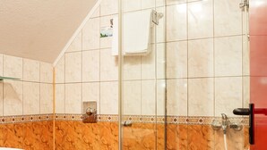 A bathroom with a glass-enclosed shower, a white toilet, and a white sink. - Saint George Hotel & Spa (Pomorie)