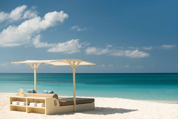 On the beach, white sand, beach cabanas, sun loungers - The Ritz-Carlton, Grand Cayman (Seven Mile Beach)