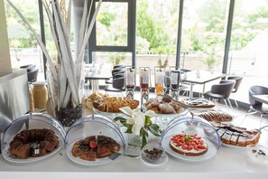 A breakfast buffet with various pastries and desserts. - Sotel Nomentana (Rome)