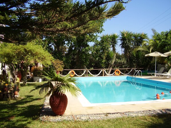 Seasonal outdoor pool, open 9:00 AM to 9:00 PM, pool umbrellas