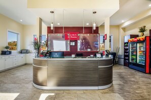 A reception area with a curved counter, a Dell computer, a Coca-Cola refrigerator, and a sign indicating Wi-Fi availability. - Red Roof Inn Madison Heights, VA (Madison Heights)