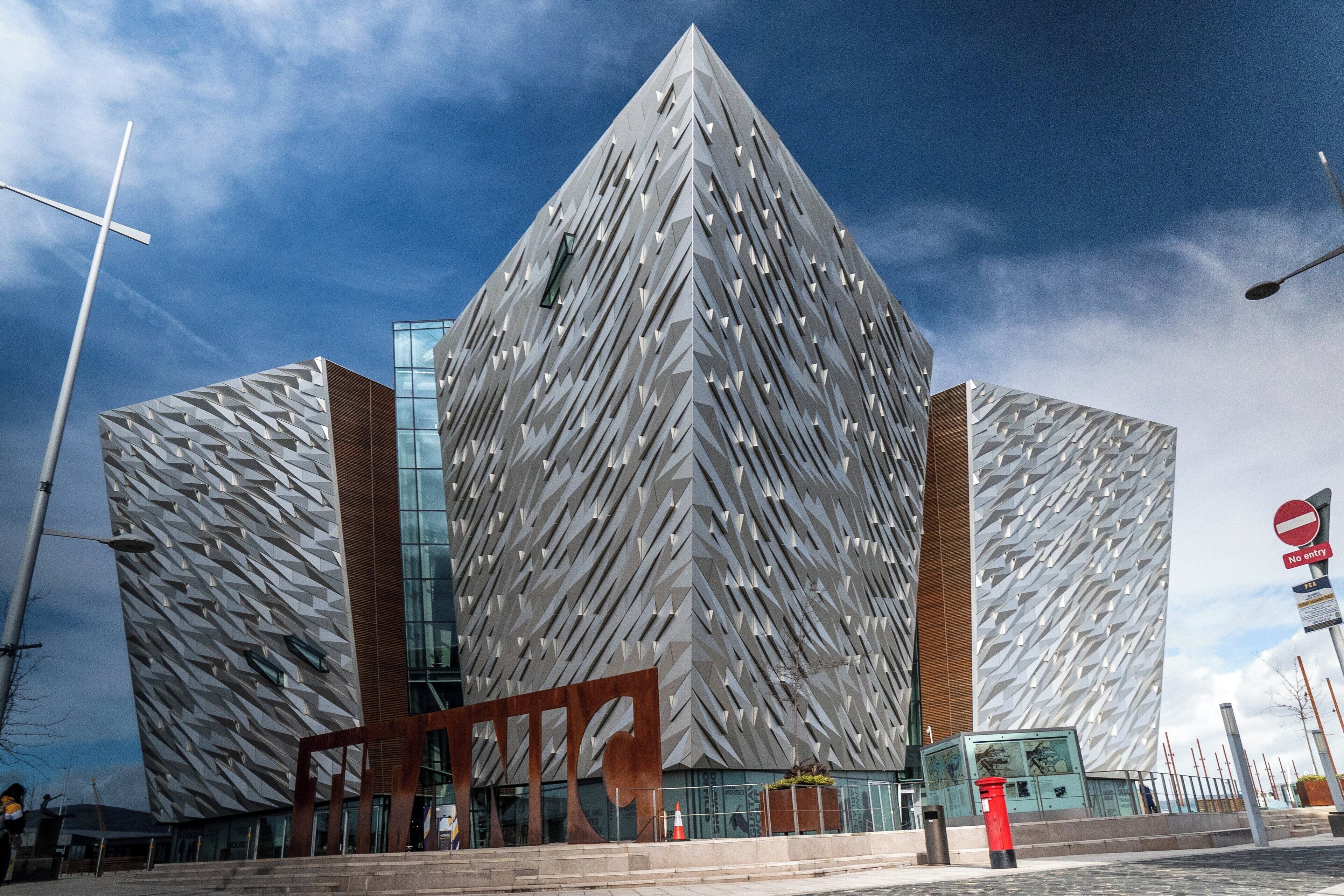 A modern building with a distinctive geometric facade and a prominent entrance.