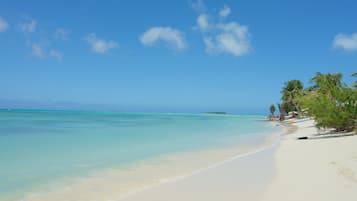 On the beach, white sand, free beach cabanas, sun loungers