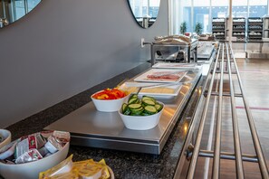 A buffet area with various food items and utensils. - CABINN Aarhus Hotel (Aarhus)