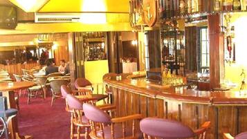 A bar area with wooden chairs and a bar counter.