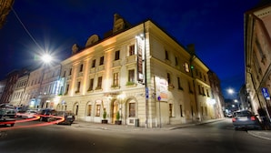 A historic building with a sign indicating it is a hotel. - Hotel Regent (Kraków)