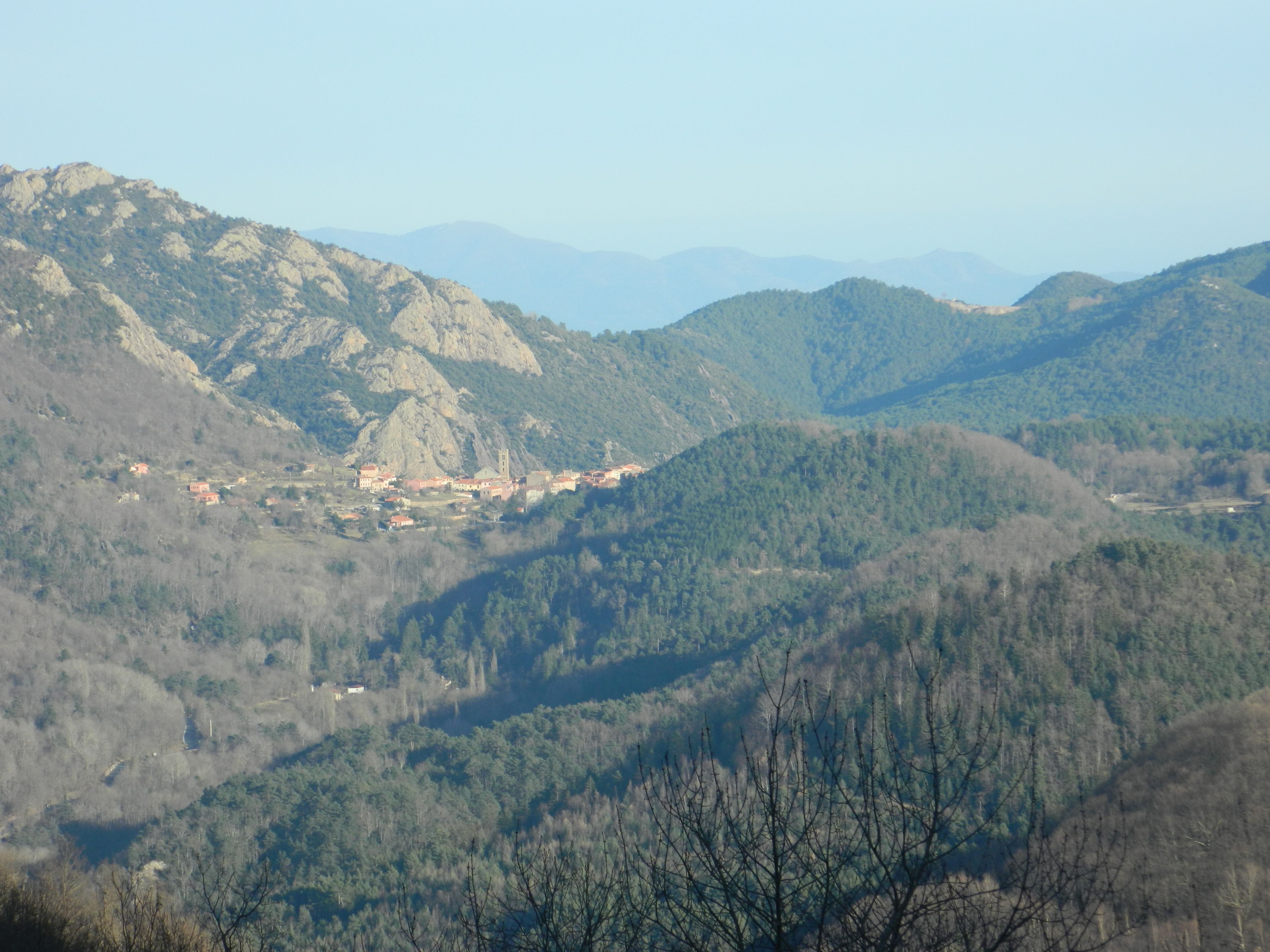A mountainous landscape with a small village nestled among the hills.