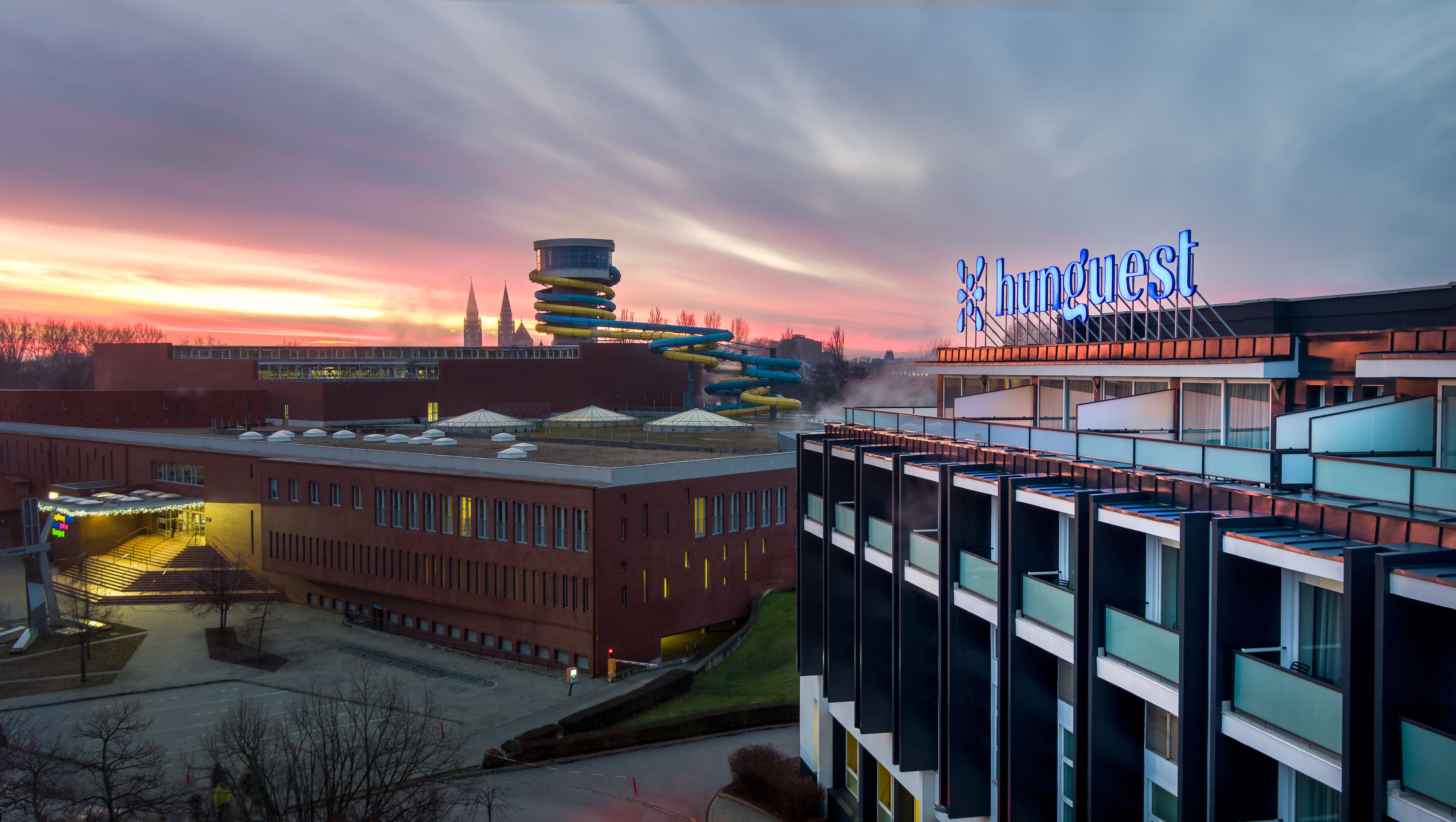 A modern hotel with a distinctive tower and a sign reading "InnQuest."