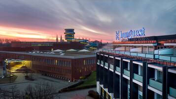 A modern hotel with a distinctive tower and a sign reading "InnQuest."