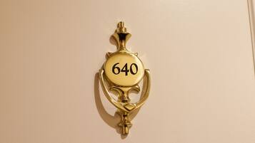 A brass doorbell with the number 640.