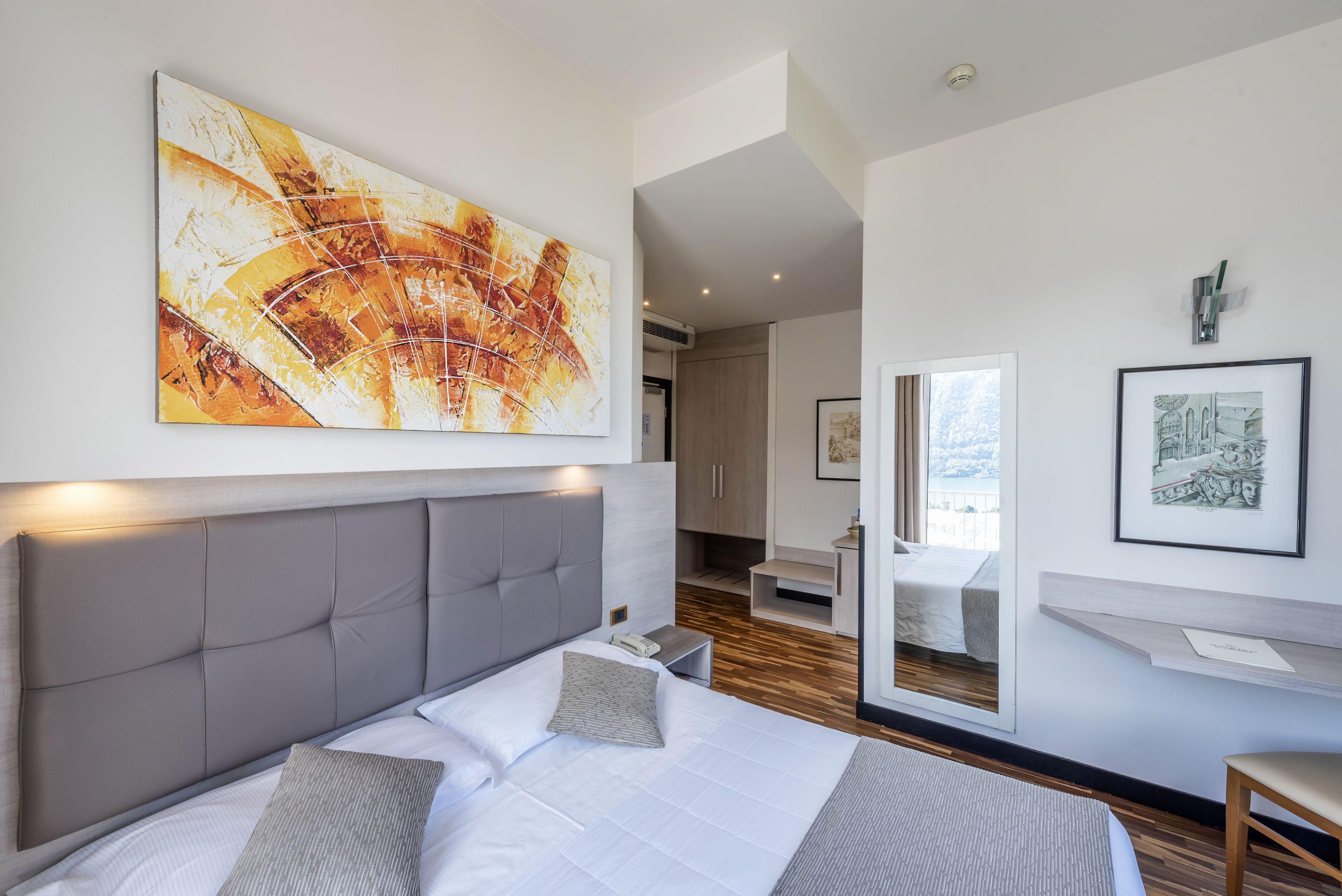 standard double room, balcony, lake view | minibar, in-room safe, desk, laptop workspace