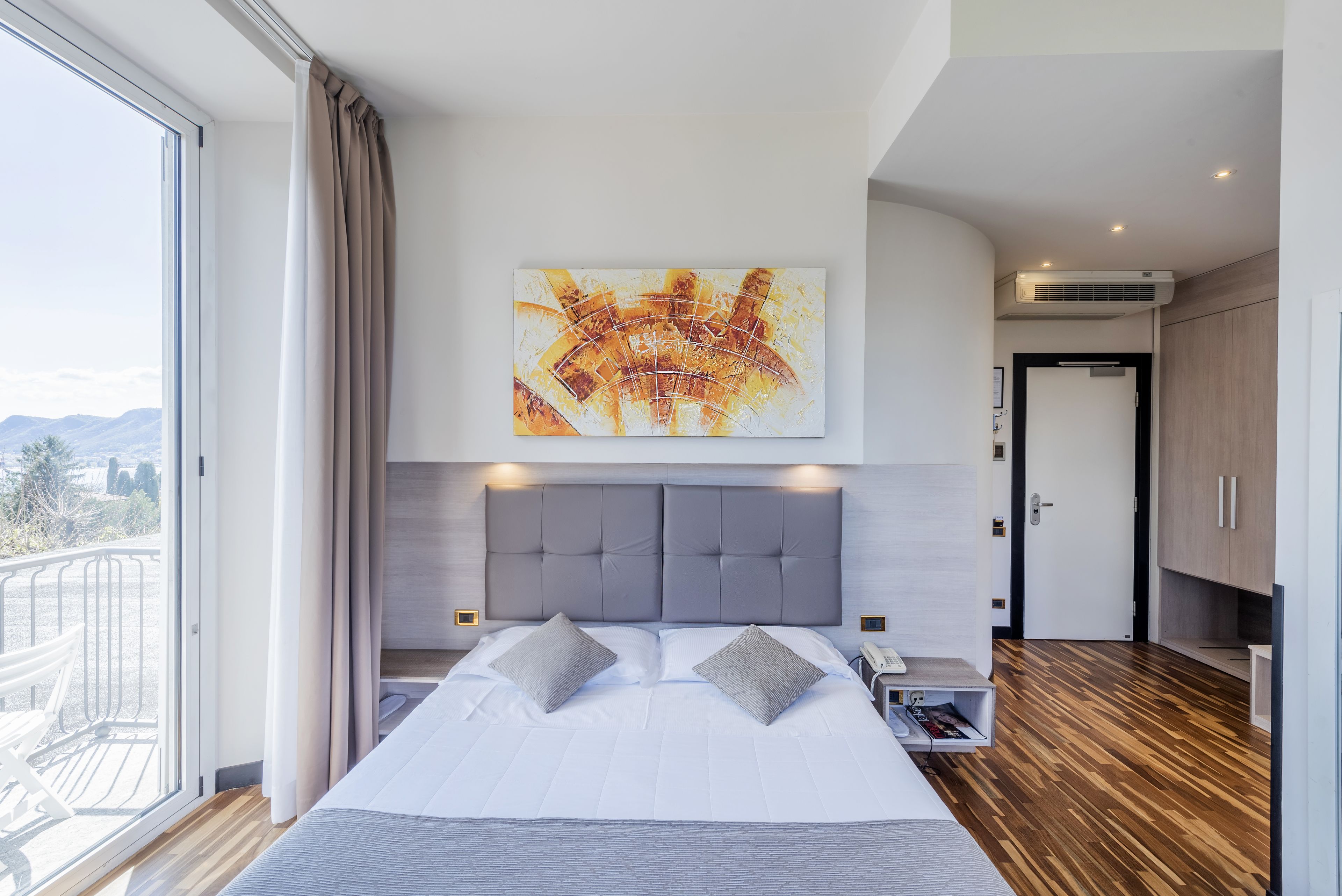 standard double room, balcony, lake view | minibar, in-room safe, desk, laptop workspace