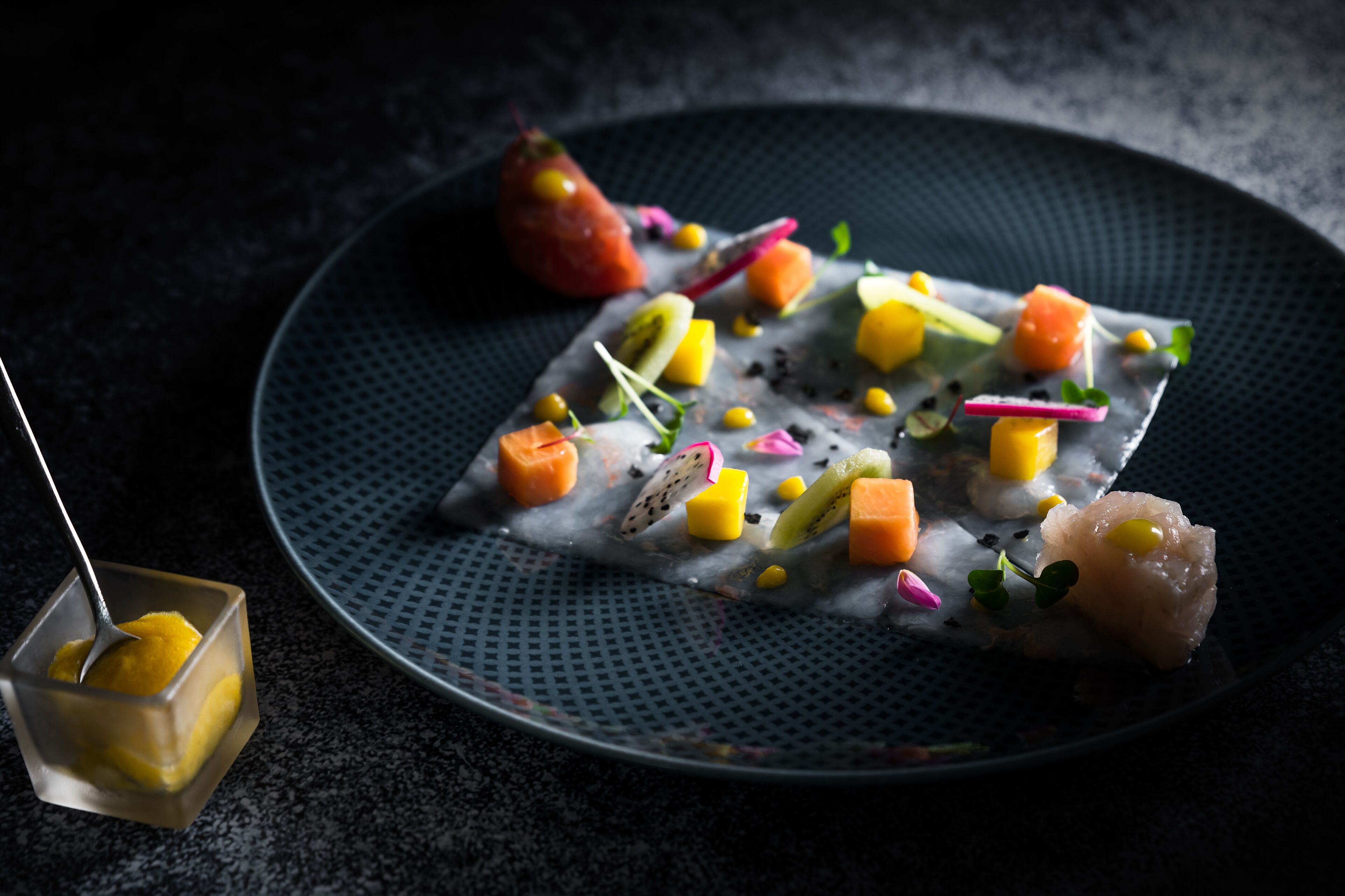 A plate of food with various colorful ingredients.
