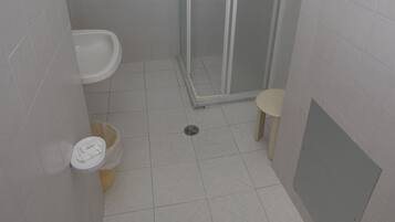 A bathroom with a shower, sink, and toilet.