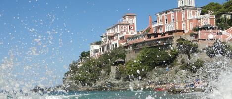 A coastal building with multiple balconies overlooking the sea.