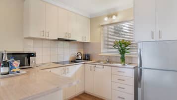 Full-size fridge, microwave, stovetop, coffee/tea maker