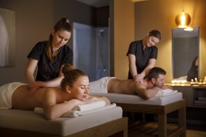 A spa setting with massage tables and a person attending to a client. - Valamar Diamant Hotel (Porec)