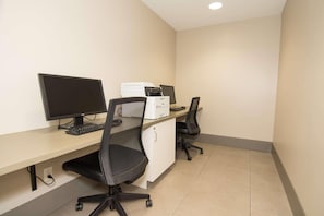 A clean, modern office space with a desk, two monitors, a printer, and a black office chair. - Country Inn & Suites by Radisson, Lehighton (Jim Thorpe), PA (Lehighton)