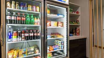 A refrigerated display case with various beverages and snacks.