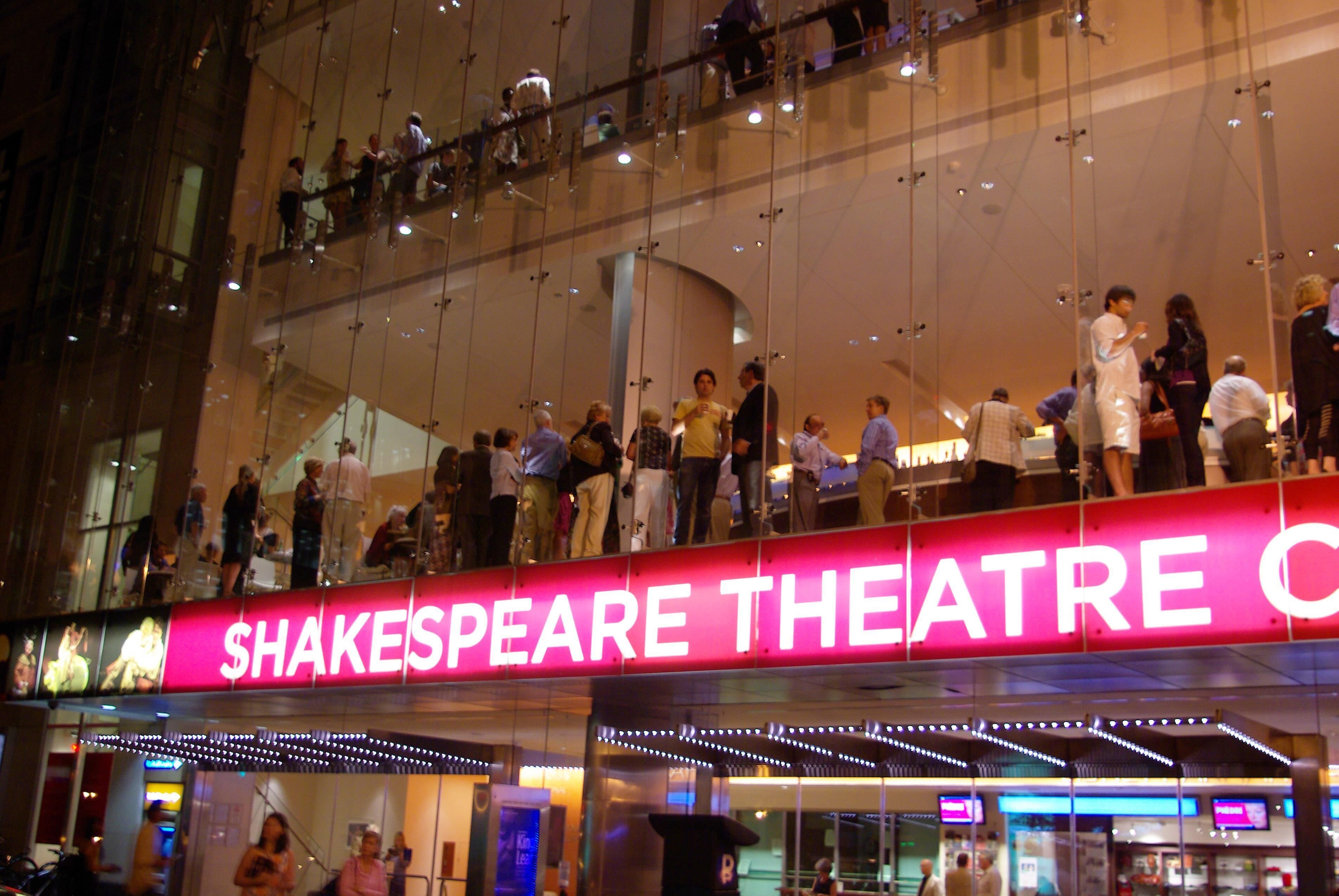 A multi-level building with a prominent sign for the Shakespeare Theatre.