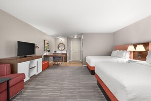A hotel room with a bed, a desk with a computer, a TV, and a red chair. - Hampton Inn & Suites Fresno (Fresno)